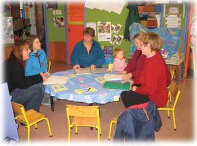 Five teachers, one infant around small table