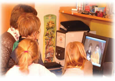 Teacher, three children, computer screen